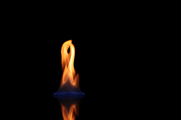 Beautiful view of flaming vodka on black background