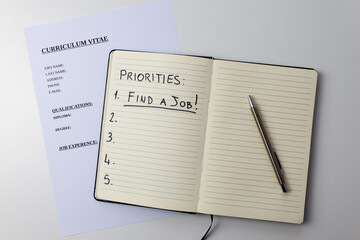 Curriculum vitae, with a notebook on it with the text 