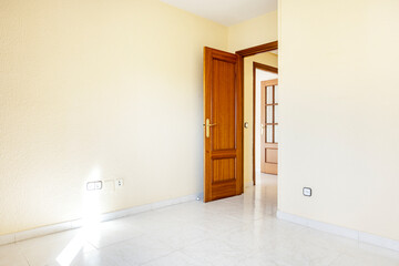 Room with white stoneware floors and dark wood doors