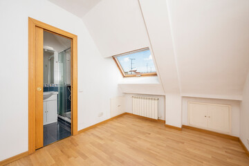 Penthouse apartment bedroom of an urban building with separate bathroom and white aluminum radiators