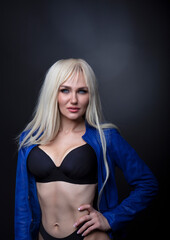 Fashionable photo of young blonde woman wearing black lingerie 