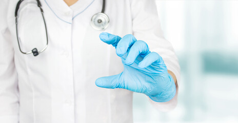 Female doctor showing something in her hand in medical gloves. Doctor presenting and showing copy space for product or text