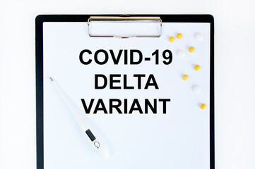 On the tablet for writing the text COVID-19 DELTA VARIANT, it has a thermometer and yellow tablets...