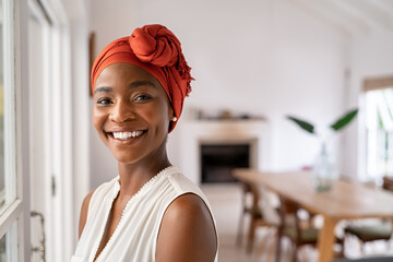 Smiling black mid adult woman wearing traditional turban - Powered by Adobe