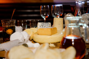 Different sorts of cheese on wooden table. Homemade chees. Assortment of different cheese types....