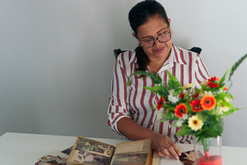 Older woman with photo album, smiling