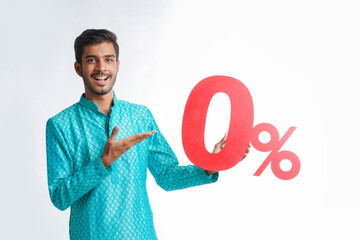 Indian man holding zero percent sign board promoting offers on festival season while wearing...