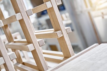 Wine rack made of solid oak and plywood during production in the workshop extreme closeup