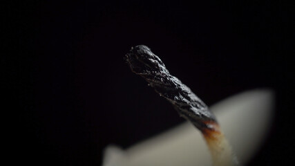 Photo of lightening a candle on black background