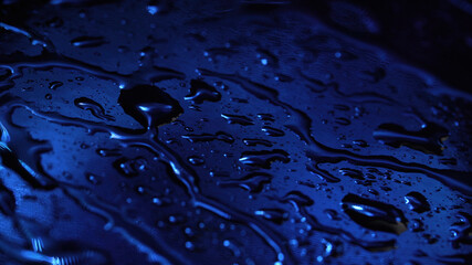 Photo of liquid drops on dark blue background
