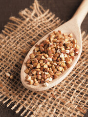 Organic buckwheat on a wooden cooking spoon