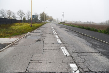 Fused and damaged asphalt road suitable for renovation and posing a threat.