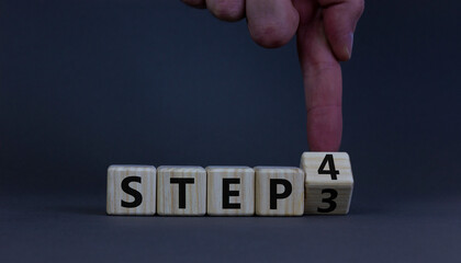 Step 3 or 4 symbol. Businessman turns a wooden cube and changes words Step 3 to Step 4. Beautiful grey table, grey background, copy space. Business and Step 3 or 4 planning concept.