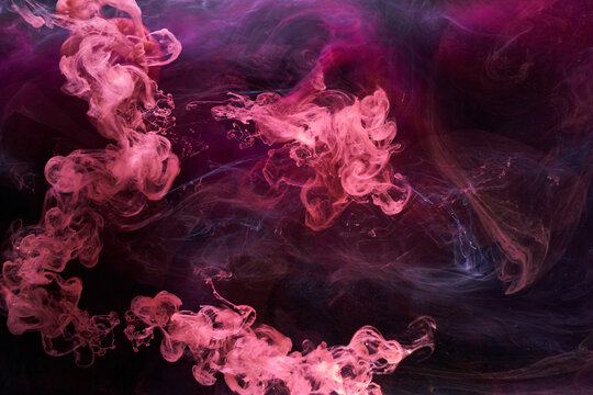 Pink smoke on black ink background, colorful fog, abstract swirling touch ocean sea, acrylic paint pigment underwater © amixstudio