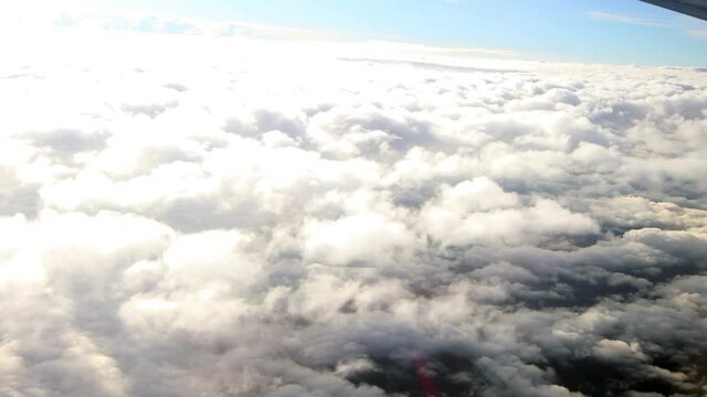 Clouds footage aerial view. Clouds taken from an international flight on the move. Fluffy clouds