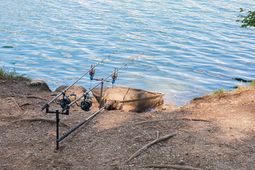 Fototapeta na wymiar sport fishing rods installed by a clean mountain lake