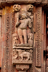 Close-up carved stone sculpture of Lord Yama at Rajarani Temple. 11th century Odisha style temple constructed dull red and yellow sandstone, Bhubaneswar, Odisha, India.