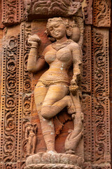 Fototapeta na wymiar Sculptures of maidens clutching trees/foliage on walls of the Rajarani temple. 11th century Bhubaneswar, Odisha, India.