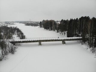 Aerial view of the bridge over the Medyanka river in winter (Murygino, Kirov region, Russia)