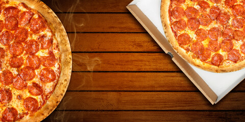 Pizza pepperoni in delivery box top view. Hot pizza salami and mozzarella cheese on wooden...