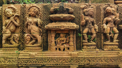 Sukasari Temple wall built in sandstone with carvings of human figures, deities, scroll work and...