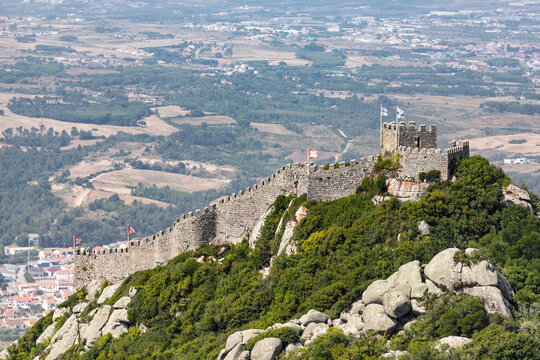 View of Sintra castle (Mori Castle) on hilltop with Lisbon city in background, Portugal.