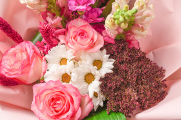 Bouquet of  soft pink flowers in pink wrapping paper.