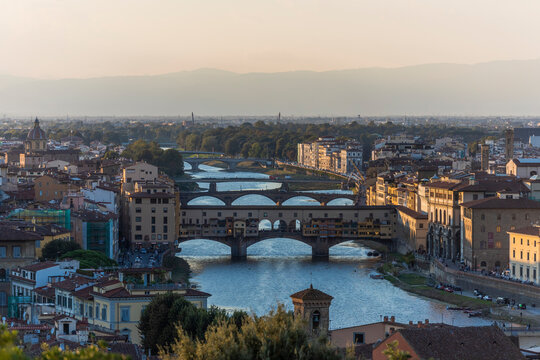 View of Florence downtown from Piazzale Michelangelo, view of Arno river and Ponte Vecchio in background at sunset, Tuscany, Italy.