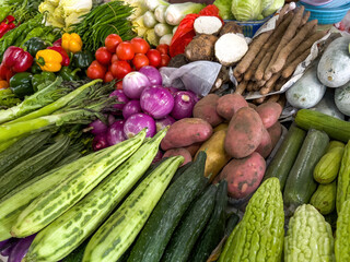 The vegetable and fruit stalls in the Chinese vegetable market are full of various vegetables