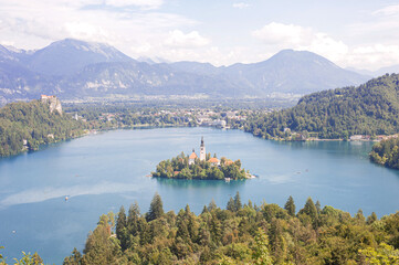Fototapeta premium castle in the middle of a clean mountainous emerald lake Bled against the backdrop of the Slovenian Alps