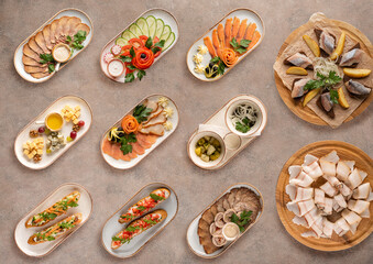 A large set of snacks on a beige background.