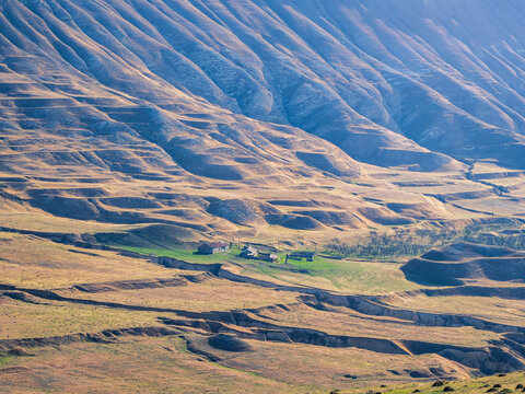 Texture of wavy mountain slopes. Mountain texture, mountain terrain. Dagestani hills from above.