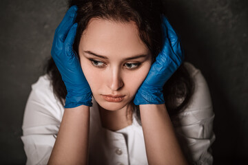 Nurse worker have headache migraine feel bad pain tired owerworked stressed touching temples. Female doctor dressed medical white gown blue sterile rubber gloves, healthcare overwhelmed