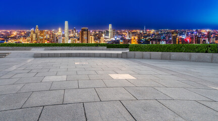 Empty brick floor with city skyline background