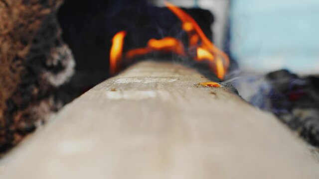 Burning Fire. Fireplace. Real wood logs. Camping. Keeping warm. Tongues of flame engulfed the log.