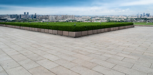 Empty brick floor with city skyline background