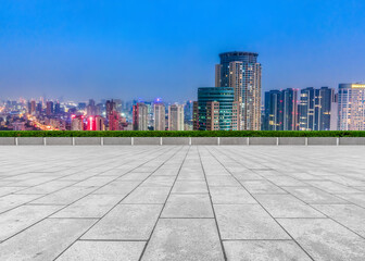 Empty brick floor with city skyline background
