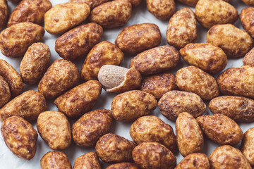 Pile of candied or sugared almond with honey and cinnamon, close-up. Traditional Christmas sweets for holidays