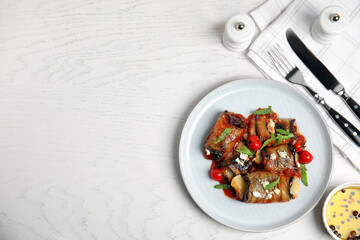 Delicious baked eggplant rolls served on white wooden table, flat lay. Space for text