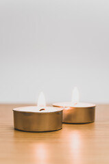 Obraz na płótnie Canvas pure wax scented tea lights on a wooden background with space for text