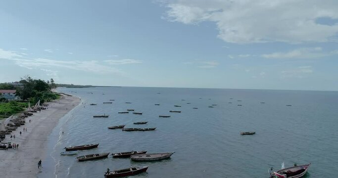 Wooden fishing boats scattered on the shore in Bagamoyo 