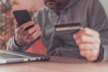 E-commerce and electronic banking concept, man using smartphone and credit card online