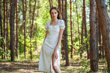 Portrait of a young beautiful woman posing in the forest