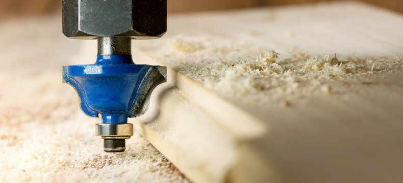 woodworking and carpentry. cutting the edge of the board with router. joinery background. copy space