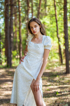 Portrait of a young beautiful woman posing in the forest