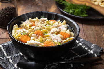 Steaming bowl of chicken noodle soup