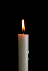 One candle with light isolated on a black background