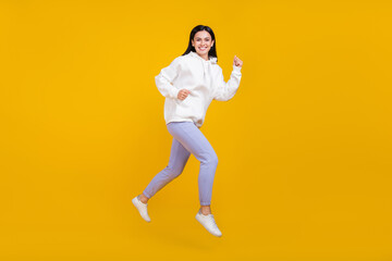 Fototapeta na wymiar Full body profile side photo of lady jump run fall season discounts shopping concept isolated over bright yellow color background