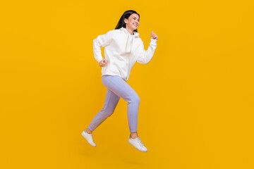 Fototapeta na wymiar Full length profile side photo of youth lady jump practice sprint race run street style isolated over shine yellow color background