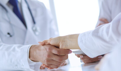 Doctor shaking hands with a male patient in the office